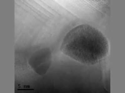 Two particles of gold atoms merging together under an Electron Microscope.