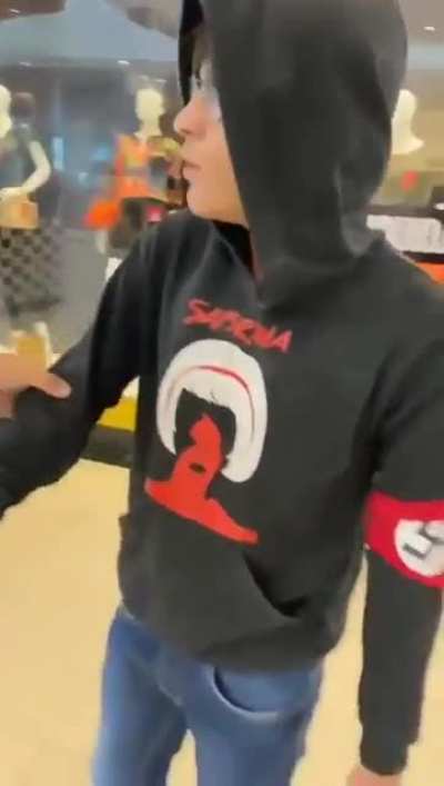 Guy in a shopping mall with the swastika symbol