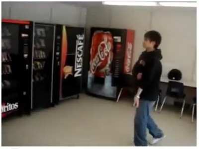 Kid hits a vending machine with "flying jump tackle"