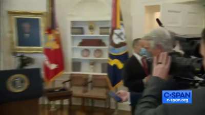 Orange man walks out of medal of freedom ceremony leaving recipient shrugging.