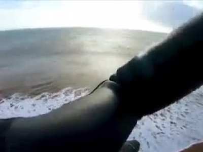 Kite surfer jumps 600ft on an island.