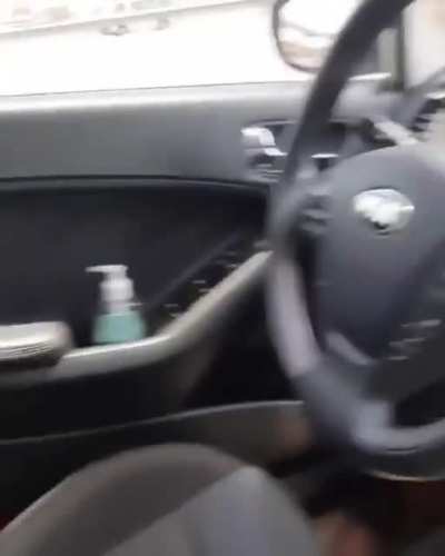 Idiot but we must give him credit for carrying a hand sanitizer in his car