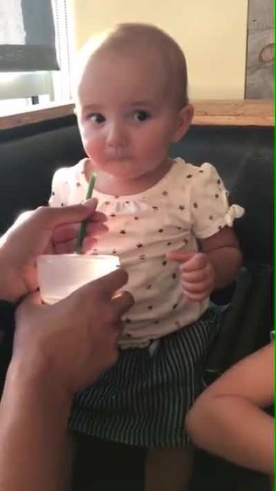 baby trying chocolate milk for the first time