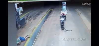 Oblivious motorcycle driver dumps his motorcycle in a pit. He promptly slides on his face.