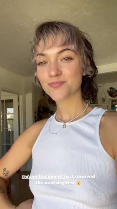 Playing with her new haircut
