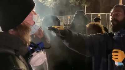 During protests against police brutality in Minneapolis a white man from outside the area threw a projectile at police and is kicked out by locals who live there