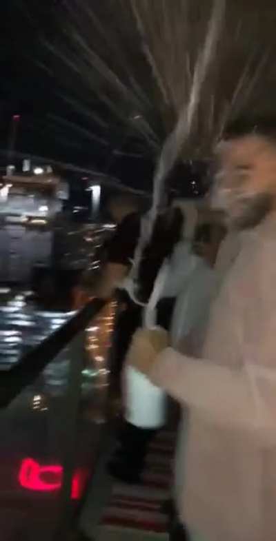Champagne Bottle Cork Smacks a Guy Face After Shaking the Bottle