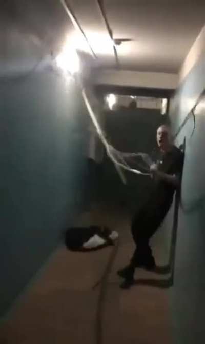 Some guy high out of his mind in apartment hallway ripping out electrical