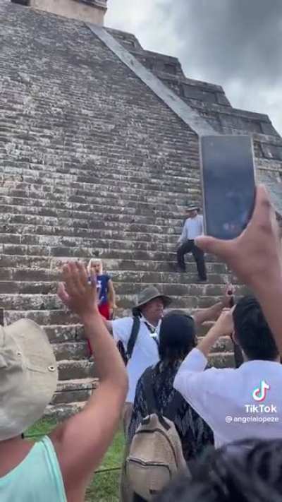 Disrespectful woman climbs a Mayan Pyramid and gets swarmed by a crowd when she comes down