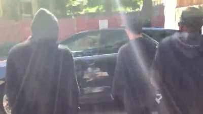 Antifa protestors smash up car which contains a dog and someone they believe to be their political enemy