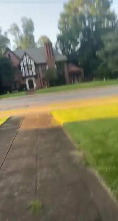 A guy hits a police car with a golf ball