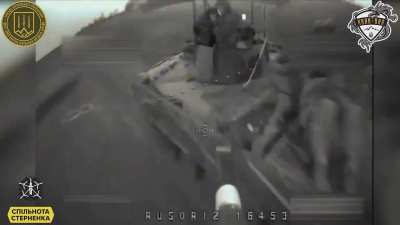 Russian infantry on the back of a BMP attempt to shoot down a Ukrainian FPV drone, but the drone hits the vehicle anyway
