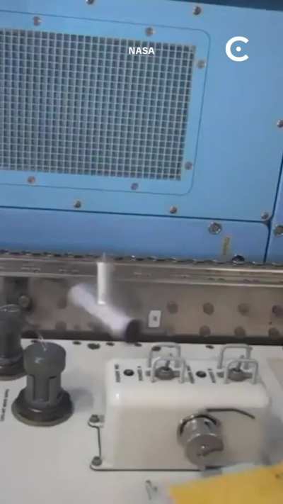 An astronaut demonstrating the Dzhanibekov effect in microgravity, where an asymmetric object spinning around its intermediate axis becomes unstable and periodically flips 180 degrees