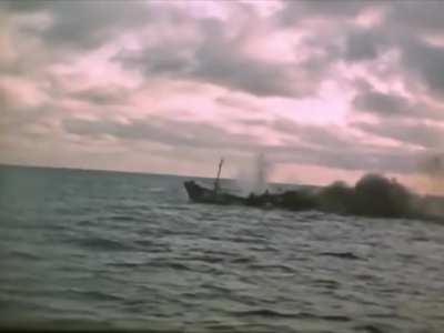 Gato-class submarine USS Barb (SS-220) sinks a small Japanese vessel with gunfire in 1945