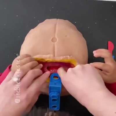A doctor mother made her kid a playdough moulage of a C-section as a birthday gift. Her Twitter handle is watermarked.
