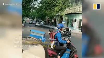 Delivery courier in China goes to work with baby girl in tow
