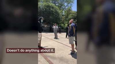 Retired Cook County judge, Robert Bertucci, takes a swing at a protester in Chicago.
