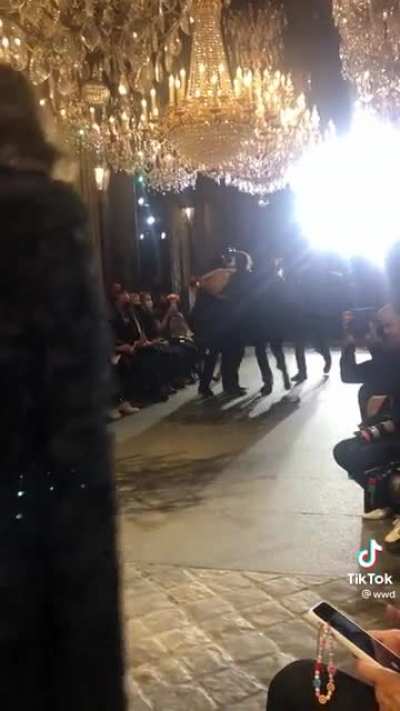 People protesting at Louis Vuitton show. [loud]