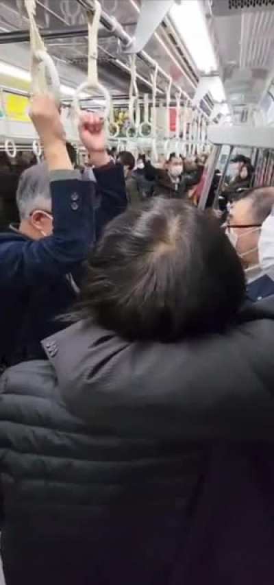 Two men fighting quietly in Japan so they don&rsquo;t disturb others in the subway