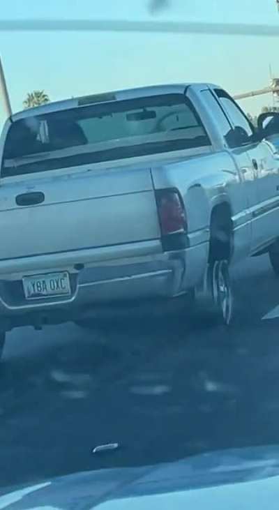 Truck driving on a blown out wheel casually