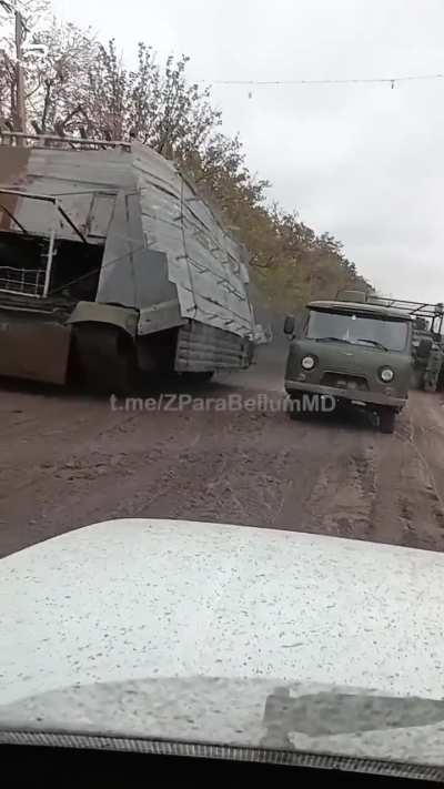 RU POV: Russian "Turtle" tank running past troops and vehicles nicknamed: "Босс мангалов" Barbeque boss.