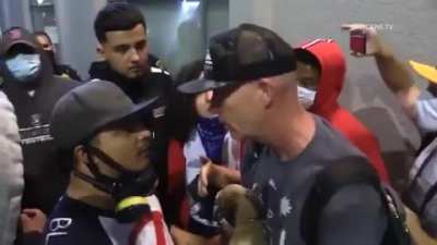 Guy in San Diego claims he was witness to police shooting and it was justified. Crowd gets upset and asks him to leave. He attempts to leave and is punched. Crowd asks everyone to stop filming