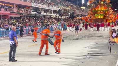 Trash sweepers at the end of a carnival parade in Brazil