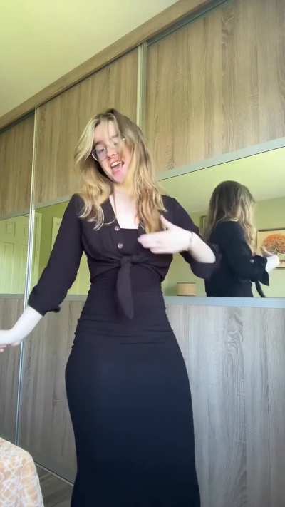 In a tight black dress