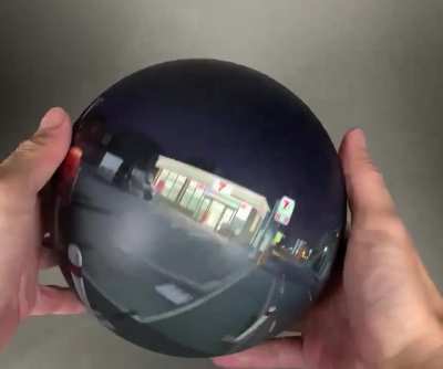 A 360&deg; painting of a night scene on a sphere plays tricks with perspective.
