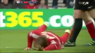 Soccer player got his shin slashed by the opponent's cleats.