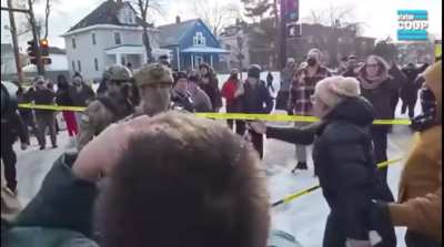 ICE agent pulls weapon on crowd and appears to fumble around with the trigger.
