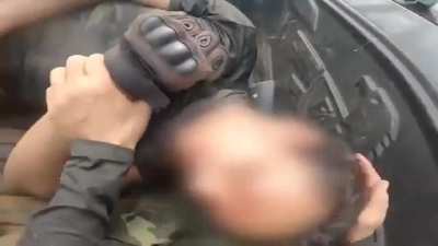 Anti-Junta medic trying get a wounded comrade stay conscious, Karenni State.