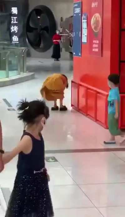 A woman in Beijing&rsquo;s Shijingyan Wanda Plaza after she received a phone call confirming she tested positive for COVID-19