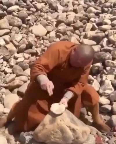 Monk breaks stones with his fingers
