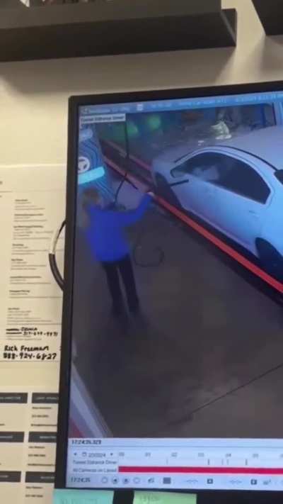 Throwing a lemonade cup at a teenage car wash worker