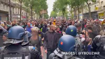 People chanting "Libert&eacute;" in Paris as they protest against mandatory vaccinations of health care workers and vaccination passports on Bastille Day, a national holiday in France.