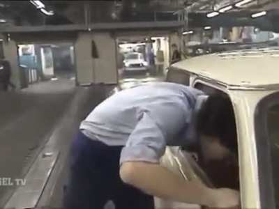 Quality control and end of line repairs at the Trabant factory. With kicks, hammer and mullet.