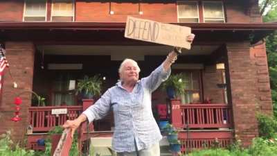 This 83 year old woman holding a sign that says &ldquo;Defend black voices&rdquo;
