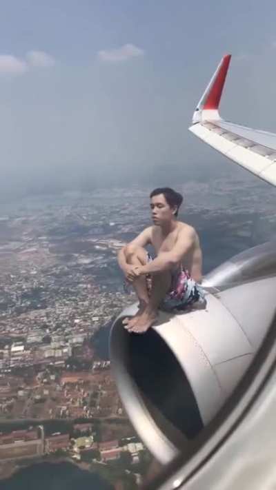 This guy enjoying the breeze on the plane's smoking deck