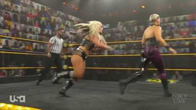 Toni Storm catching Rhea Ripley low with her foot
