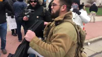 Former Ferguson cop who showed up with a rifle yesterday and was asked to put it away shows up with a rifle bag containing a large dildo today.