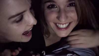 Two girls giving a blowjob in a cinema