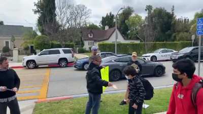 Anti-maskers harassing kids in front of an Elementary school.