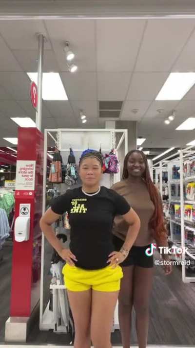 Storm Reid In Yellow Shorts + Black Shirt