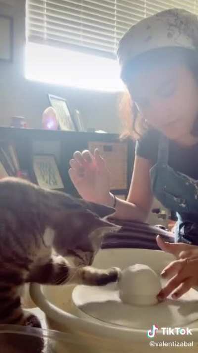 Helping his mom do some pawttery