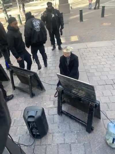 White woman kissing boots of Black Hebrew Israelites a separatist hate group known of their antisemitic and anti-white beliefs