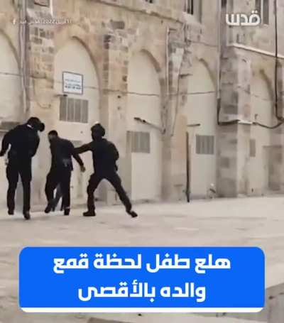 Palestinian child panics while Israeli forces are attacking his father in the courtyard of Al-qasa mosque