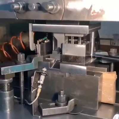 Metal tabs being shaped and stamped.