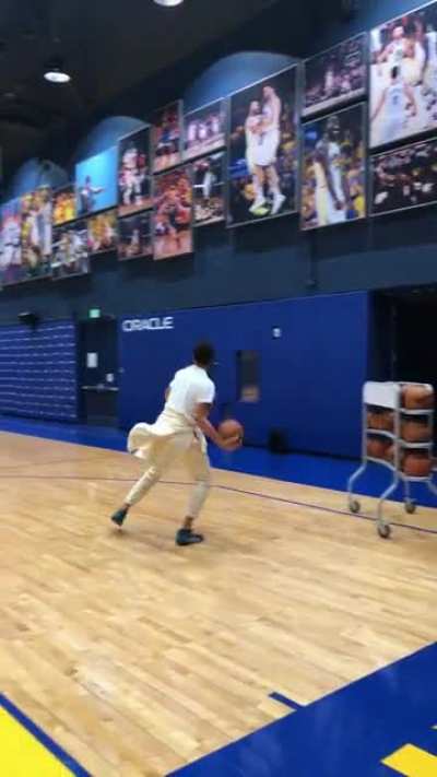 Steph Curry casually draining full court shots after practice.