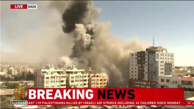 footage_of_the_moment_an_I S R A E L I_air strike_bombed a building with the offices of The Associated Press and Al Jazeera in Gaza City. this is clearly not an act of defense